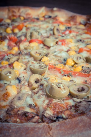 Vintage photo, Fresh baked vegetarian pizza with vegetable, italian cuisine, fast foodの写真素材