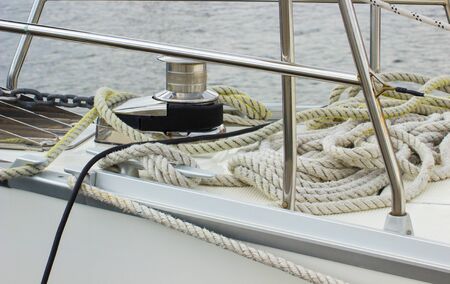 Yachting, coiled rope and bollard on sailboat, details and part of yacht