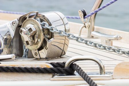 Yachting, black rope and chain on deck of sailboat, details and part of yacht
