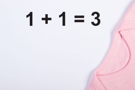 Clothing for newborn, concept of extending family and expecting for baby, copy space for text or inscription on whiteの写真素材