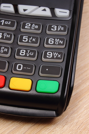 Credit card reader on wooden desk, payment terminal, finance and banking conceptの写真素材