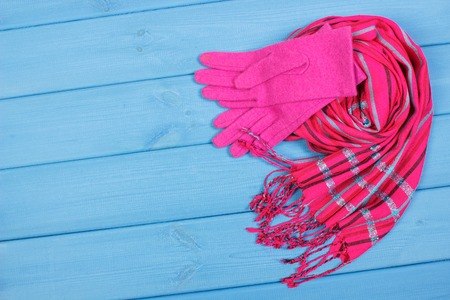 Womanly woolen gloves and shawl on boards, warm clothing for autumn or winter, copy space for textの写真素材