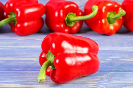 Red peppers lying on purple boards, concept of healthy nutrition