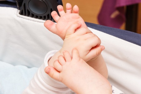 Sweet tiny hand and feets of newborn baby, concept of babies careの写真素材