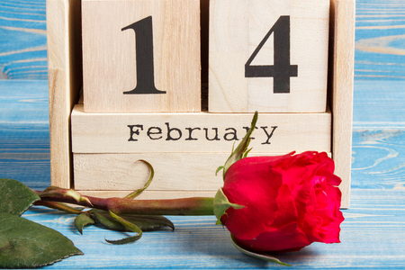 Date of February 14 on cube calendar and red rose flower, decoration for Valentines dayの写真素材