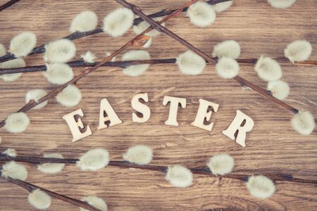 Vintage photo, Inscription Easter and catkins on rustic board, festive decoration conceptの写真素材