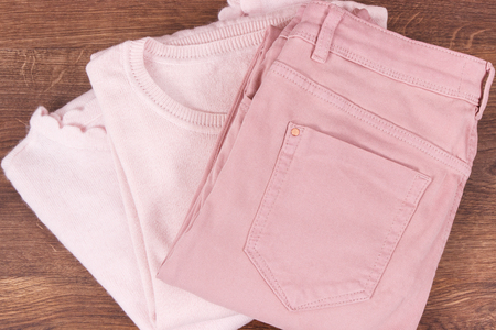 Cotton pants and woolen sweater for woman lying on rustic boardsの写真素材