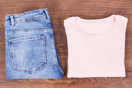 Womanly woolen sweater and pants lying on rustic boardの写真素材