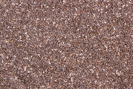 Chia seeds as background, concept of food containing natural vitamins, minerals and dietary fiberの写真素材