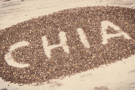 Vintage photo, Inscription chia and heap of seeds, concept of healthy food containing natural vitamins, minerals and dietary fiberの写真素材