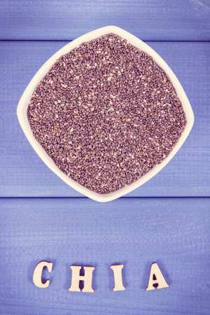 Vintage photo, Inscription chia and seeds in bowl as source natural vitamins, minerals and dietary fiber, concept of healthy food and nutritionの写真素材
