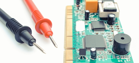 Cable of multimeter and micro circuit board on white background, electronics concept