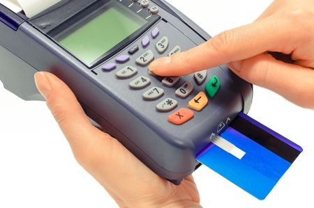 Using credit card and payment terminal, enter personal identification number, cashless paying for...