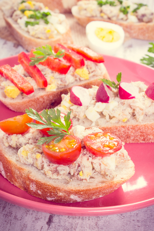 Vintage photo, Sandwiches or baguette with fresh mackerel or tuna fish paste on glass plate, healthy nutrition conceptの写真素材