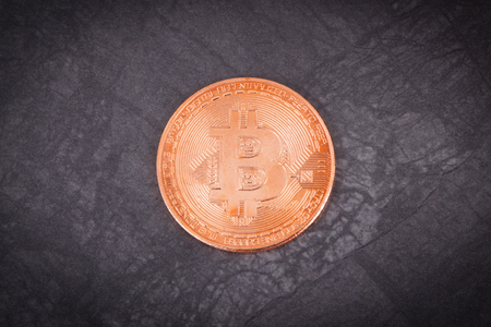 Bitcoin as symbol of electronic virtual money, cryptocurrency coin on dark background, concept of modern finance and bankingの写真素材