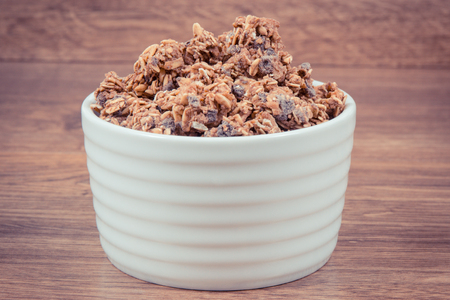 Oat flakes or granola with chocolate containing iron and dietary fiber, healthy snack or dessert conceptの写真素材