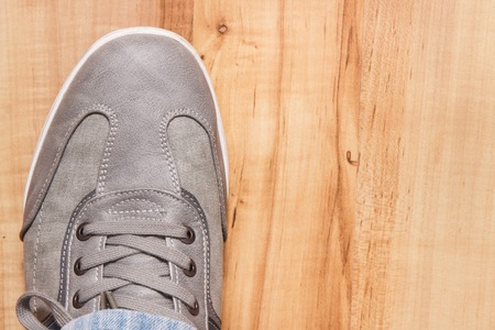 Elegant stylish comfortable gray shoes for men on board, place for inscriptionの写真素材