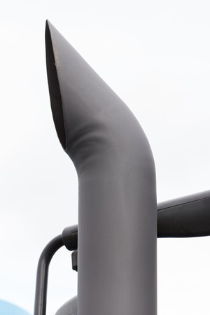 Closeup of exhaust pipe of truck or other industrial machine, reduction smoke in transportation...