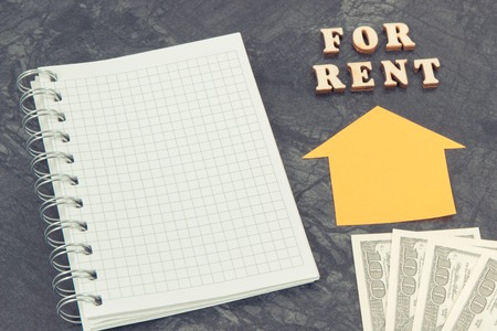 Currencies dollar, notepad for notes and inscription for rent, renting house or flat concept