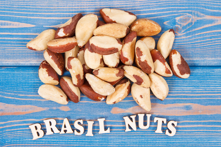 Inscription brasil nuts and heap of fruits as source of natural minerals and vitamin, healthy nutrition conceptの写真素材