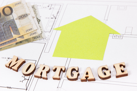 Inscription mortgage, money and home shape on electrical construction drawing, concept of buying or building houseの写真素材