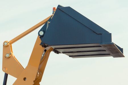 Closeup of shovel of excavator or bulldozer. Detail of part of industrial or agricultural machineryの写真素材