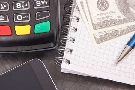 Credit card reader, mobile phone with NFC technology for cashless payment transaction, notepad for...