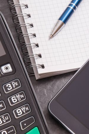 Payment terminal, smartphone with NFC technology and notepad for writing notes.の写真素材