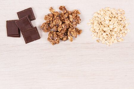 Granola, oat flakes and chocolate as source iron and fiber, healthy snack or dessert concept, place for text or inscriptionの写真素材