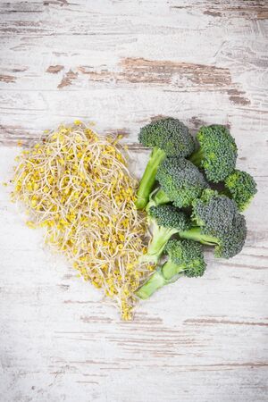 Heart shape made of broccoli sprouts and fresh ripe vegetable. Healthy eating as source natural vitamins and mineralsの写真素材