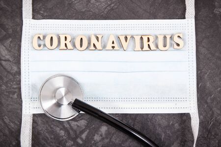 Inscription coronavirus with surgical or protective mask and stethoscope. Novel Chinese coronavirus outbreak. 2019-nCoVの写真素材