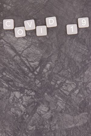 Inscription covid 19 on black background. Novel coronavirus outbreak. 2019-nCoV. Place for textの写真素材