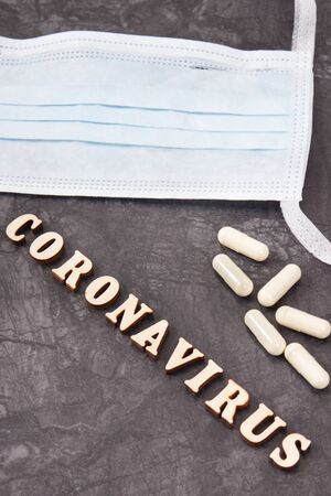 Inscription coronavirus with surgical or protective mask and tablets. Novel Chinese coronavirus outbreak. 2019-nCoVの写真素材