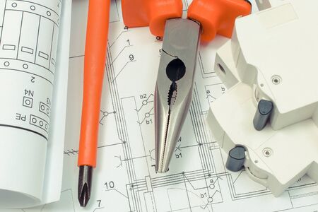 Electrical diagrams, electric fuse and work tools on construction drawing of house. Building home concept. Drawings for projects engineer jobsの写真素材