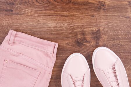 Womanly pink leather shoes and cotton pants, copy space for text on rustic boardsの写真素材