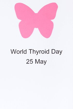 Pink thyroid shape made of paper and inscription World Thyroid Day 25 May. Problems with thyroid. White background. Copy space for text or inscriptionの写真素材