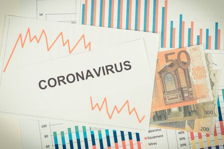 Currencies euro with downward graphs representing financial crisis caused by coronavirus. Covid-19....