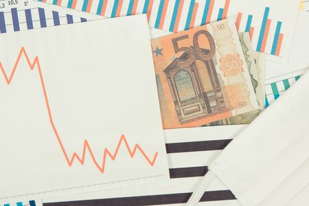 Currencies euro and downward graphs representing financial crisis caused by coronavirus. Global...