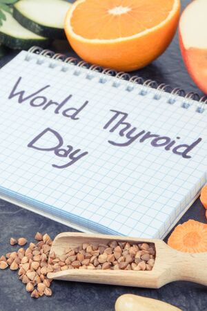 Notepad with inscription World Thyroid Day and best food containing natural minerals and vitamins for healthy thyroidの写真素材