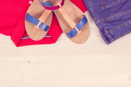 Womanly leather sandals, jeans trousers and shirt, concept of casual clothing for woman, copy space for text on white boardの写真素材