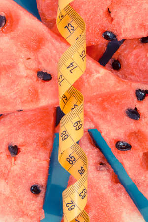 Vintage photo, Fresh juicy watermelon and tape measure, concept of delicious healthy dessert and slimmingの写真素材