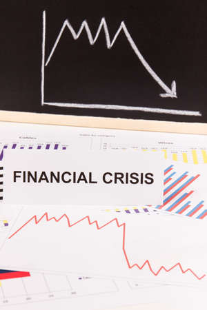 Inscription financial crisis and downward graphs representing financial crash caused by coronavirus. Risk of global recession around worldの写真素材