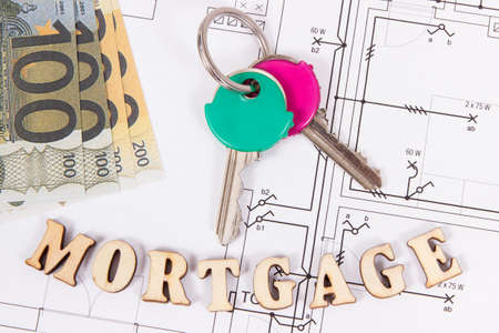 Home keys, currencies euro and inscription mortgage on construction diagrams, concept of buying houseの写真素材