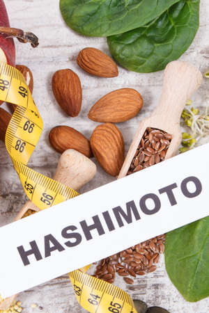 Inscription hashimoto, tape measure and best ingredients for healthy thyroid. Food containing natural minerals and vitaminsの写真素材
