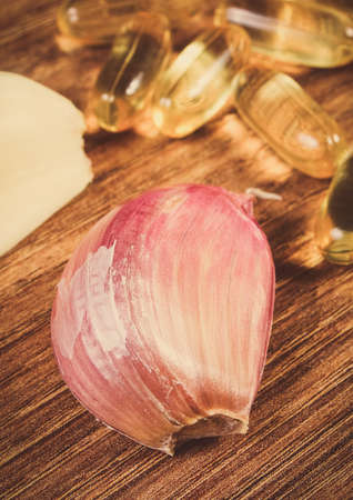Clove garlic with tablets or supplements. Alternative medicine and healthy lifestyles and nutritionの写真素材