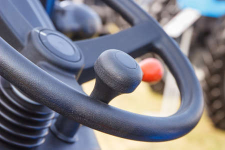 Closeup of steering wheel in agricultural and industrial machine or vehicle