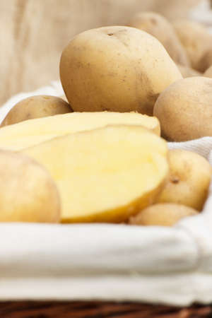 Heap of fresh potatoes in wicker basket, concept of healthy nutritionの写真素材