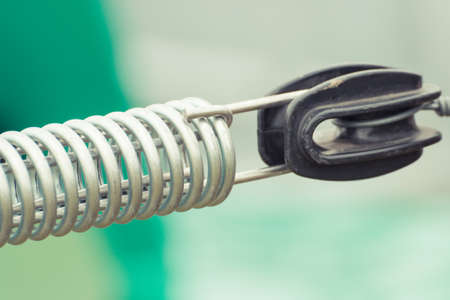 Steel spring on industrial or agricultural machinery, detail and part of hydraulic or pneumatic equipments, engineering and technology conceptの写真素材