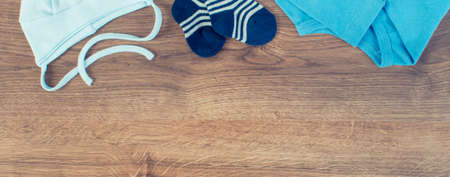 Blue clothing for newborn baby boy, concept of expecting for kids and extending family, place for textの写真素材