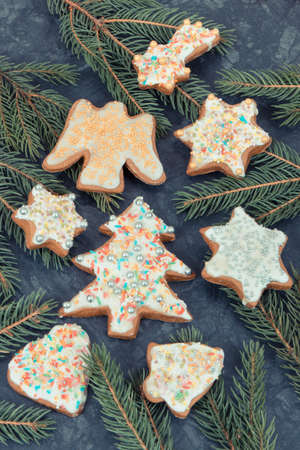 Fresh baked homemade gingerbread with decorations and green spruce branches. Christmas time